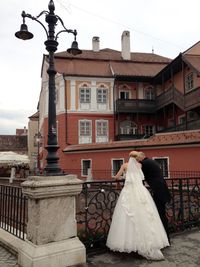 People in front of building against sky