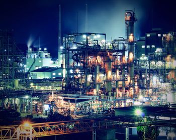 Low angle view of illuminated oil industry at night