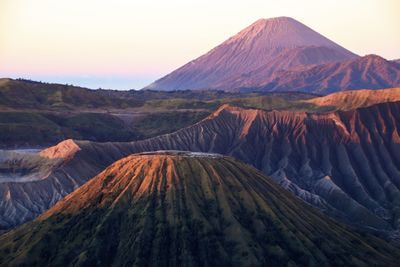 View of volcanic landscape with mountain range in background