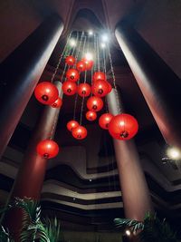 Low angle view of illuminated lanterns hanging in building