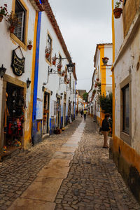 Narrow street amidst buildings in city