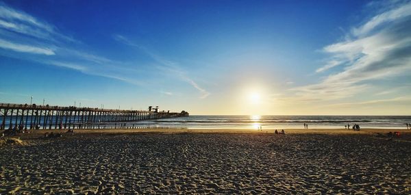 Scenic view of beach against sky during sunset