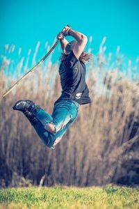 Low angle view of girl jumping on grass