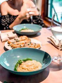 Midsection of woman having food in restaurant