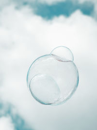 Low angle view of bubbles against sky