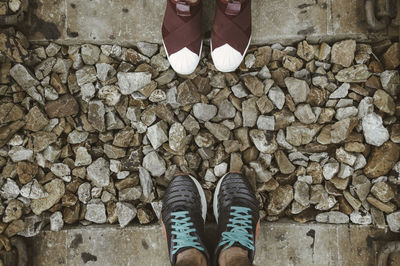 Low section of person standing on cobblestone