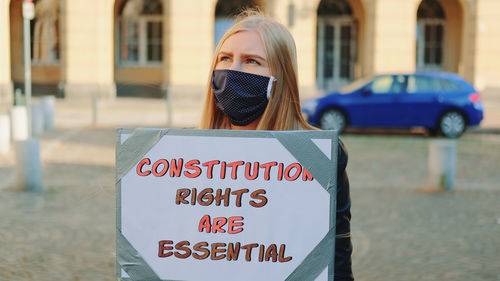 Portrait of teenage girl holding text