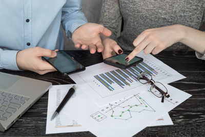 High angle view of man using mobile phone on table