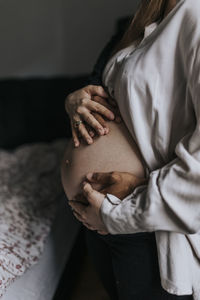 Pregnant woman with partner standing together