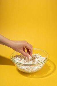Midsection of woman holding ice cream in bowl