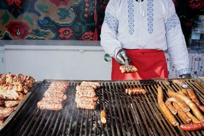 Man standing on barbecue grill