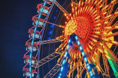 Low angle view of ferris wheel at night