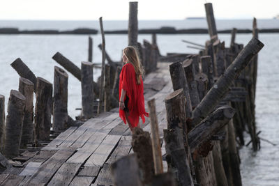 Rear view of woman walking on pier