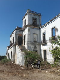 Man walking on steps at old house