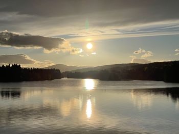 Scenic view of lake against sky during sunset