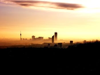 Silhouette of city during sunset