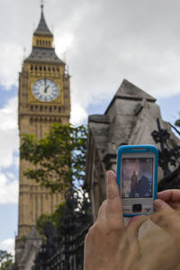 Low angle view of woman holding smart phone