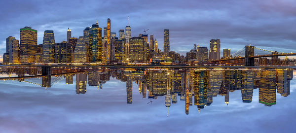 Panorama scene of new york cityscape with brooklyn bridge beside the east river at the twilight time