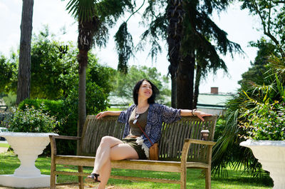 Full length of woman sitting in park