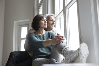 Mature couple looking out of window