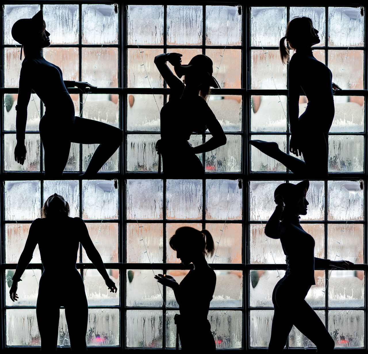 SILHOUETTE OF FRIENDS STANDING AGAINST WINDOW