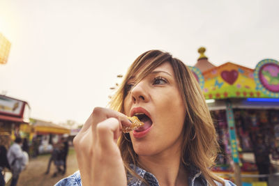 Portrait of young woman eating ice cream