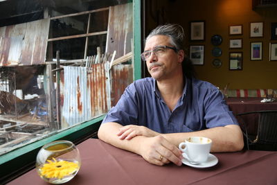 Portrait of man sitting at table