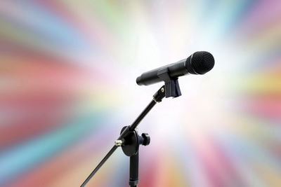 Low angle view of microphone against colorful light