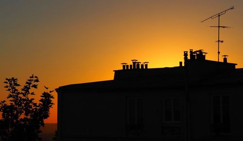 Low angle view of silhouette building against sky during sunset