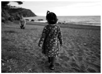 Rear view of woman looking at sea shore