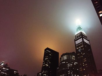 Low angle view of modern building against sky at night