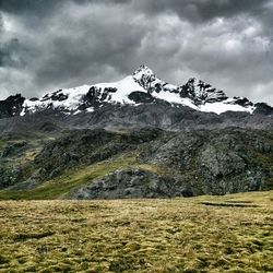 Scenic view of mountains against cloudy sky