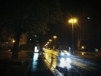 Road passing through city street at night