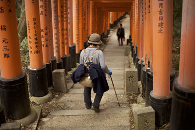 Rear view of people walking in temple building