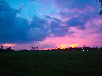 Scenic view of silhouette field against sky during sunset