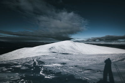 Scenic view of snow covered mountain against sky