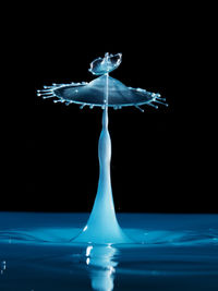 Close-up of water splashing over black background