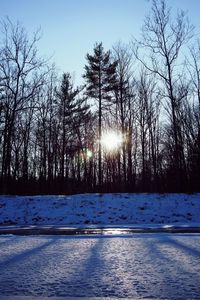 Sun shining over snow covered landscape