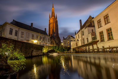 Reflection of buildings in city at night