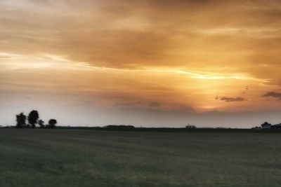 Scenic view of field against sky during sunset