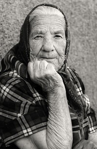 Stylish kind grandmother on a gray blurred background