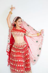 Midsection of woman standing against white background