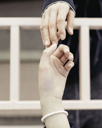 Cropped image of people holding hands
