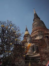 Low angle view of statue against sky