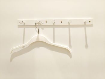 Close-up of clothes hanging on white wall