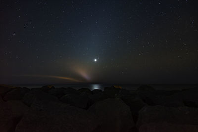 Scenic view of sea against sky at night