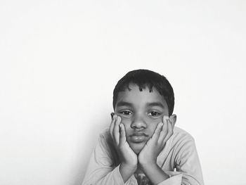 Portrait of boredom boy against white background