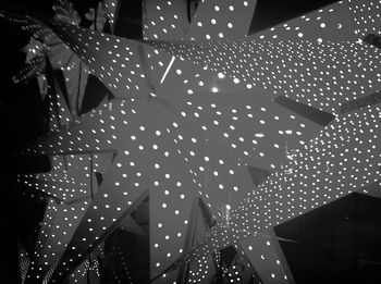 Low angle view of illuminated lights at night