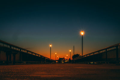 Illuminated bridge against sky at night