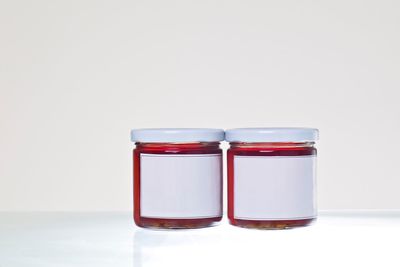 Close-up of jars on white background